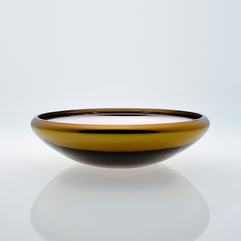 Flat round amber glass bowl with metal interior coating. Designer glass fruit bowl with mirror effect.