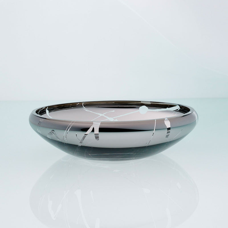 Flat round grey glass bowl with metal interior coating and splashes. Designer glass fruit bowl with mirror effect.
