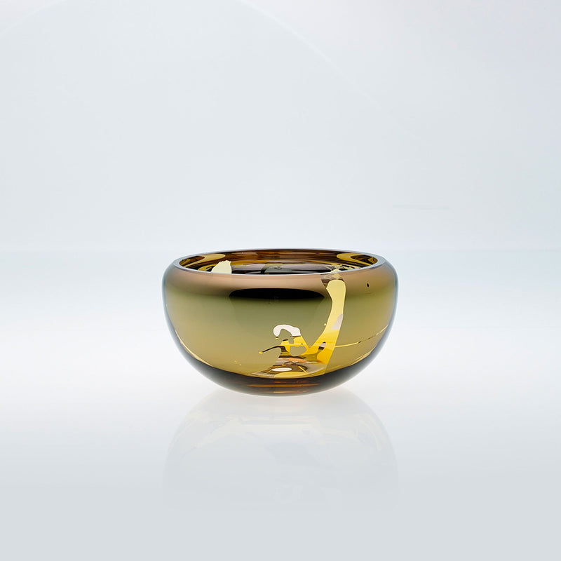Small amber round glass bowl with splashed interior metal coating. Mirror glass effect bowl.