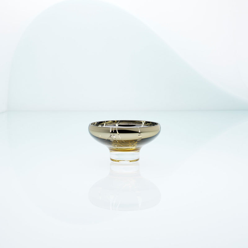 Golden amber glass mirror bowl with splashes and metal coating interior. Design dessert dish.