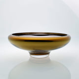 Amber glass bowl on a connected stand. Designer glass bowl with metal coating. Mirror effect glass bowl.