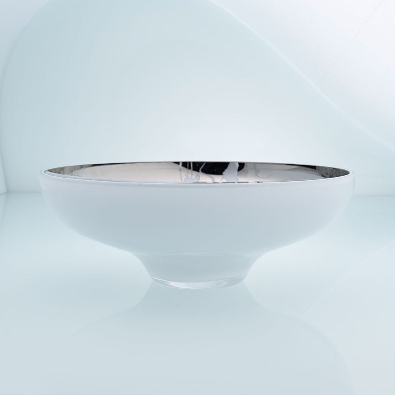Round white glass fruit bowl on a stand with interior stainless steel coating and splashes. Mirror effect design glass bowl.