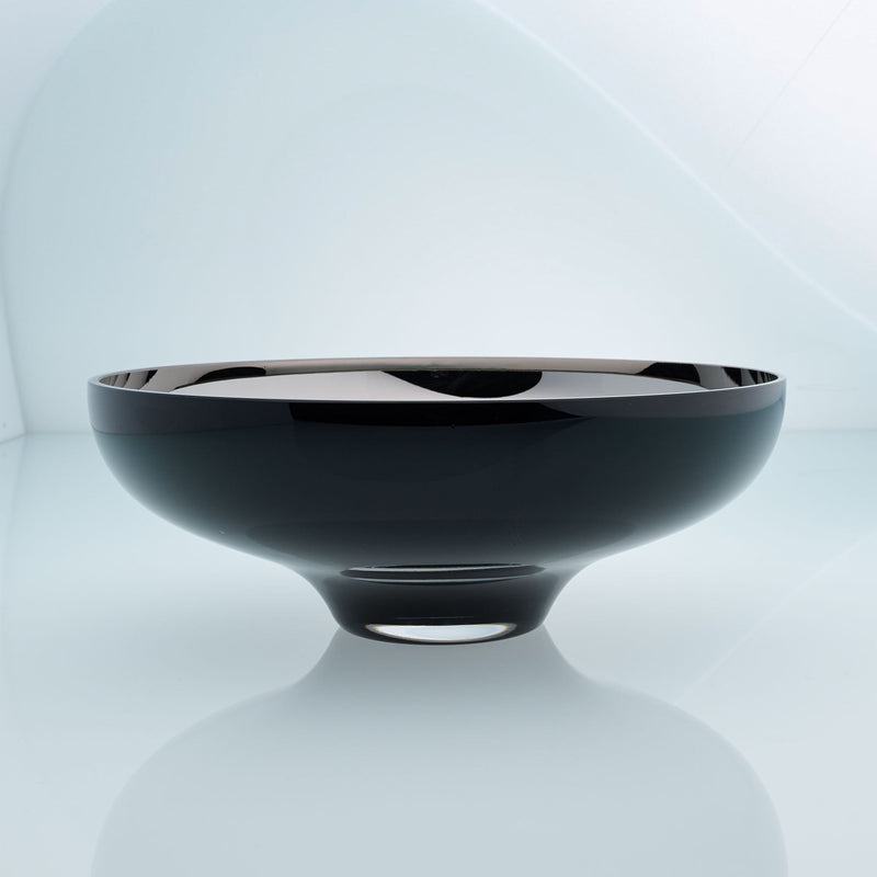 Round black glass fruit bowl on a stand with interior stainless steel coating. Mirror effect design glass bowl.