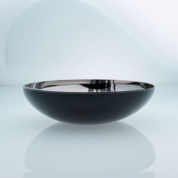 Flat round black glass fruit bowl with interior stainless steel coating and splashes. Mirror effect design glass bowl.