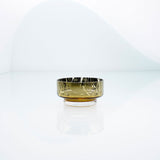 Mini, flat disk glass dessert or snack bowl in amber with metal interior coating and splashes. Designer hand made glass bowl.