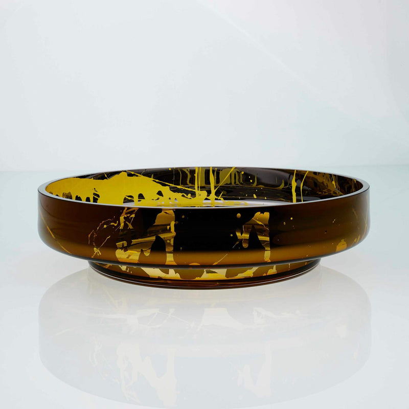 Large, flat disk glass fruit bowl in amber with metal interior coating and splashes. Designer hand made glass bowl.