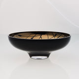 Round black glass fruit bowl on a stand with interior titanium coating and splashes. Mirror effect design glass bowl.